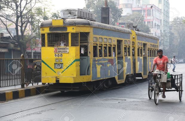 27811315-Traditional-tram-downtown-Kolkata-on-February-15-2014-Kolkata-is-the-only-Indian-city-with-a-tram-ne-Stock-Photo